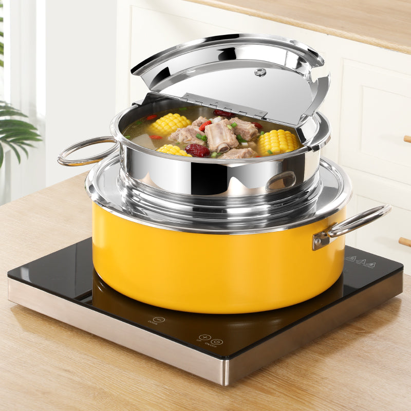 Yellow Soup Pot with a steamer insert on an induction cooktop